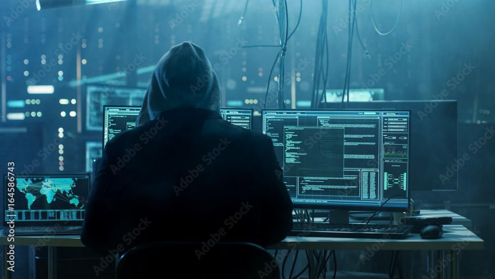 Hooded Hacker Breaks into Government Data Servers and Infects Their System with a Virus. 